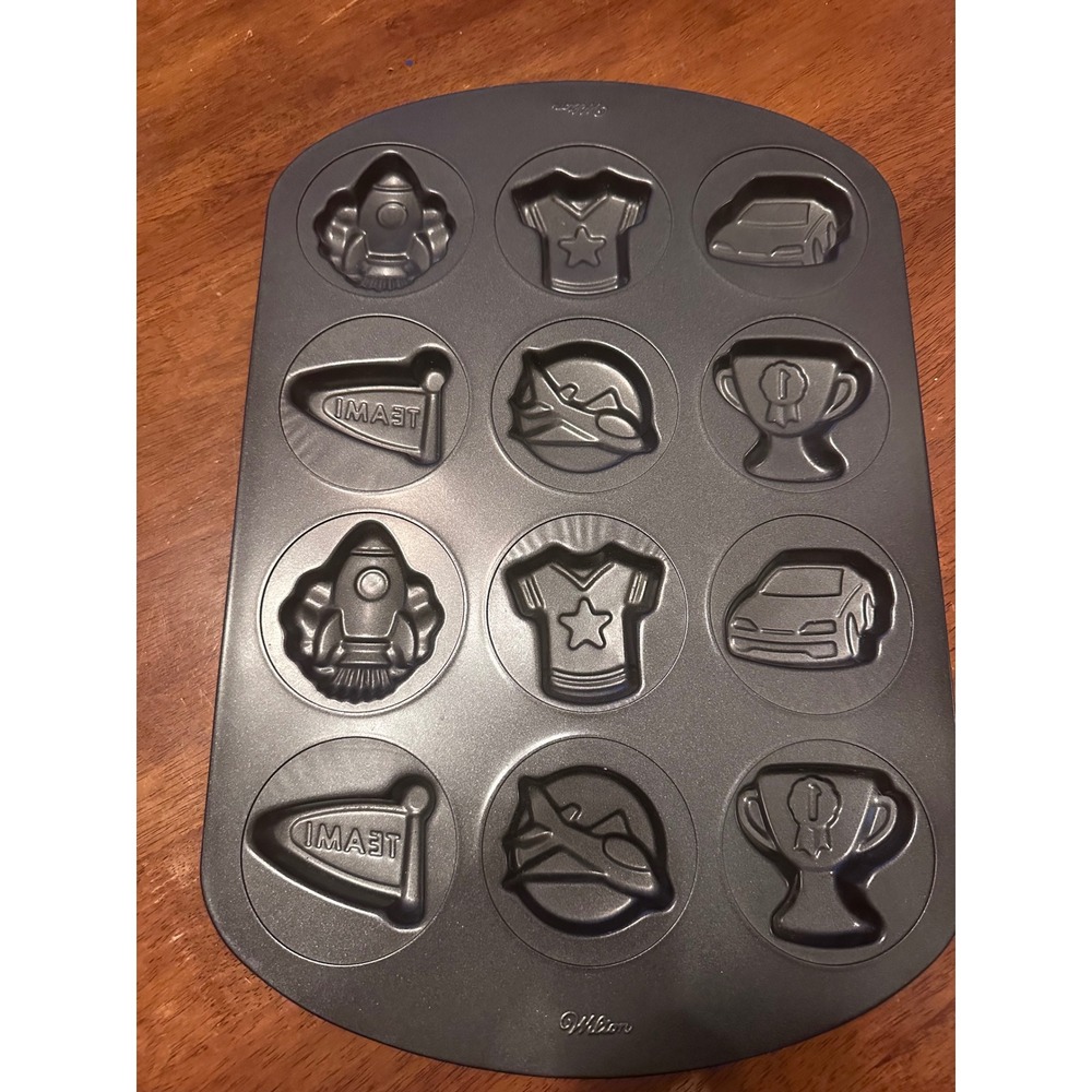 Wilton 12 Cavity Sports and Space Muffin‎ Pan Non-Stick Rocket Car Trophy Jersey